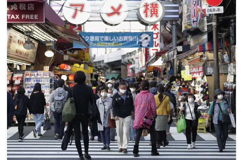 Japan's daily virus cases surge past previous record high
