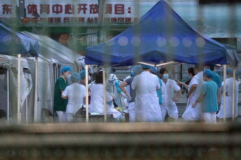 Medical workers gather to perform COVID-19 testing in Beijing as China's capital faces an &quot;extremely severe&quot; new outbr
