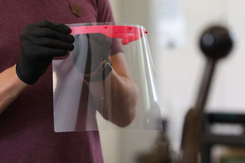 3D printers fabricate the red piece that holds a sheet of transparent plastic
