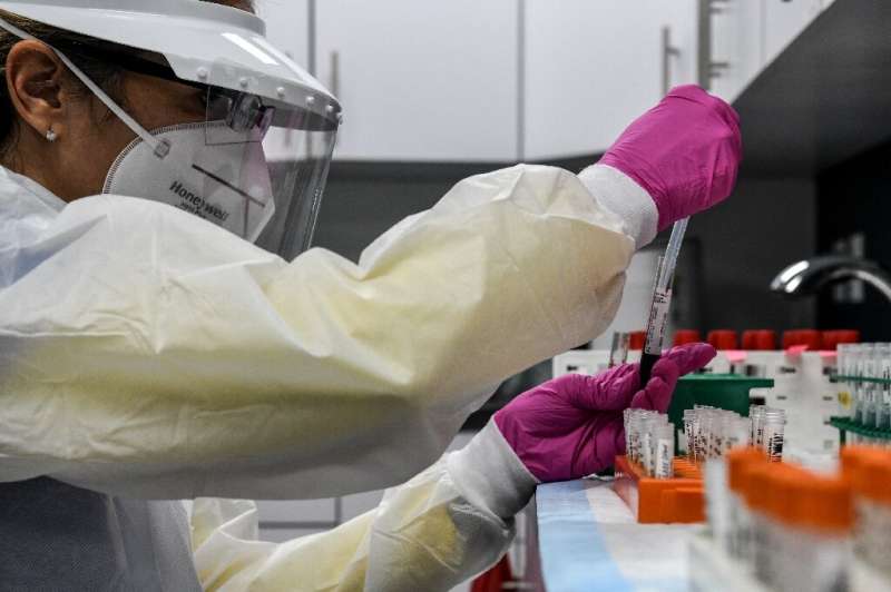 A lab technician sorts blood samples for a Covid-19 vaccination study at the Research Centers of America in Hollywood, Florida i
