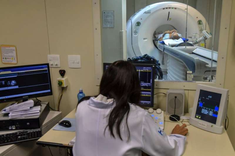 A medical worker conducts a CT scan at the University of Sao Paulo Clinical Hospital