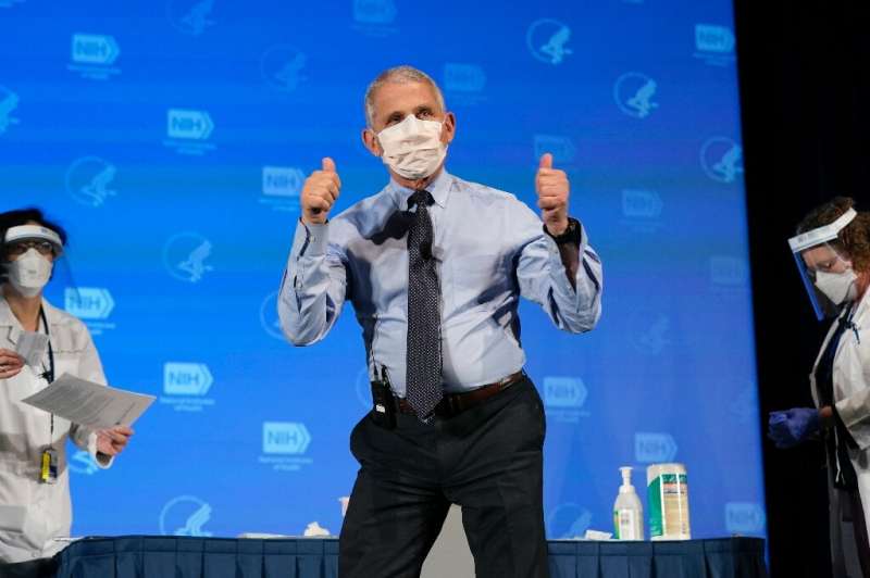 Anthony Fauci, director of the National Institute of Allergy and Infectious Diseases, gestures after receiving his first dose of
