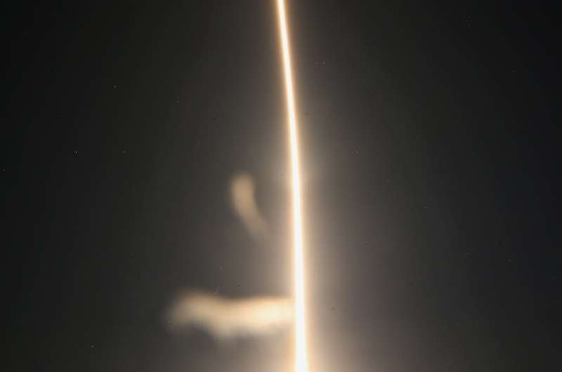 A SpaceX Falcon 9 rocket streaks toward space in this time exposure at liftoff from launch complex 39A at the Kennedy Space Cent