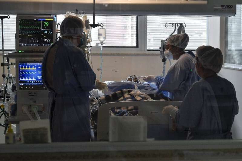 Health workers take care of a COVID-19-infected patient at the Intensive Care Unit, in the Emilio Ribas hospital in Sao Paulo, B