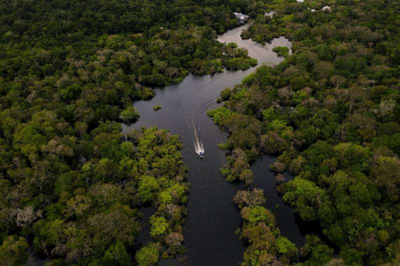 A boat speeds down the Jurura River in the Brazilian Amazon