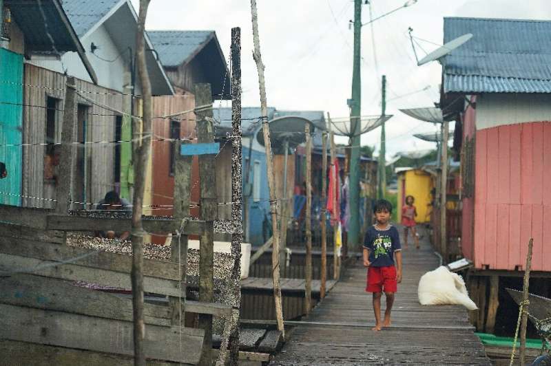 A boy walks through the town of Carauari, where residents fear the reach and spread of the coronavirus COVID-19 pandemic in the 