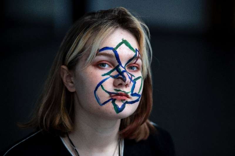 Activists in Moscow protesting the use of facial recognition technology paint geometrical shapes and lines on their faces as thi