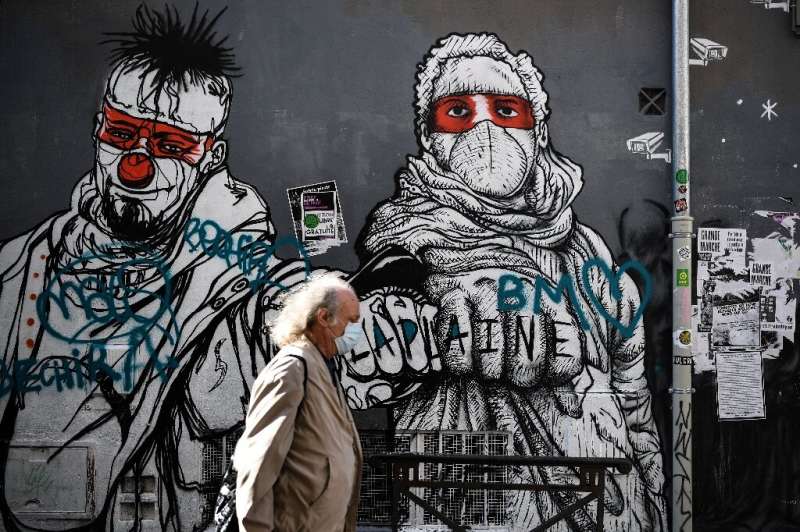 A man walks past a mural in Marseille, southern France