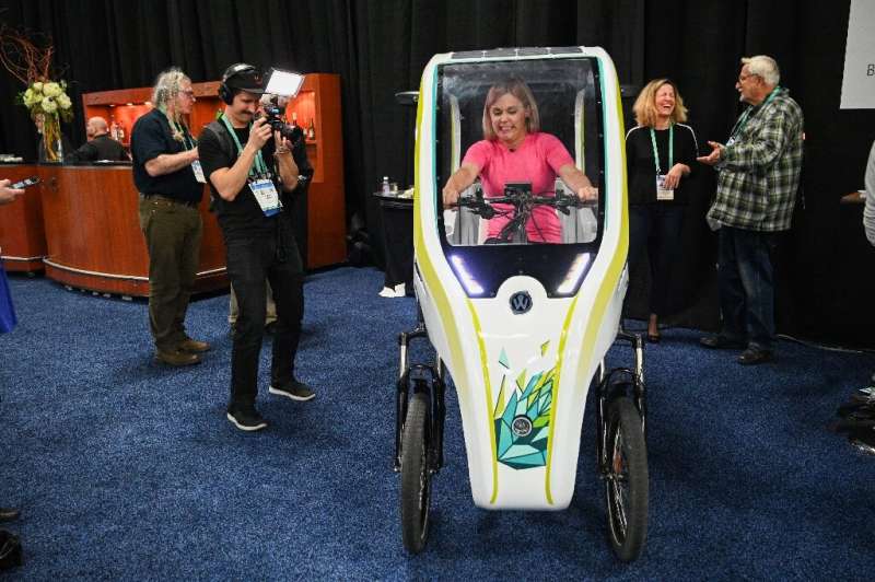 An attendee sits in the Wello solar electric tricycle during the CES Unveiled preview at the 2020 Consumer Electronics Show