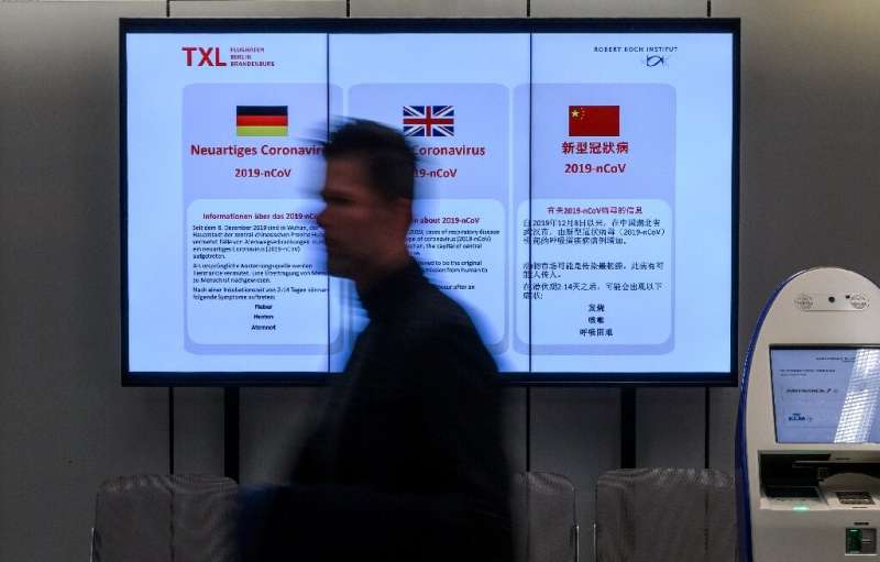 An electronic billboard at Berlin's Tegel airport displays information on the novel coronavirus—Germany and Japan have reported 