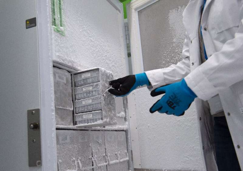 An employee opens an ultra-low-temperature freezer where Covid-19 vaccines will be stored in the Spanish Basque city of Hernani