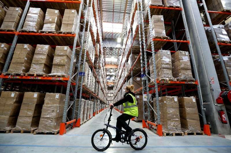 An employee rides a bicycle through a &quot;Sante publique France&quot; warehouse in Marolles, where a billion face masks are be