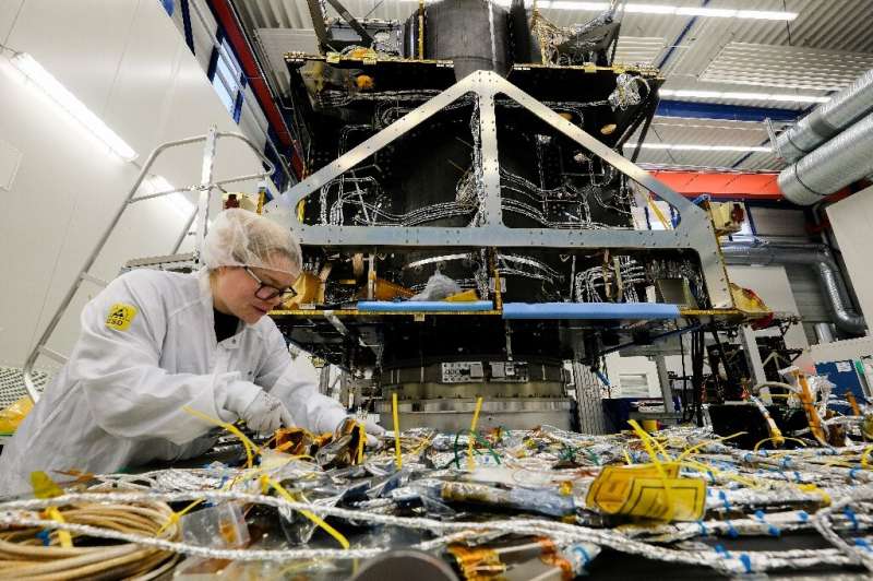 An employee works on a satellite at OHB Space Systems, a German firm that is holding its own against bigger European comptetitor