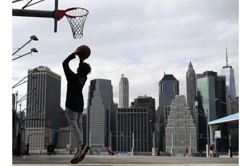 A person plays basketball alone on March 17, 2020 in New York