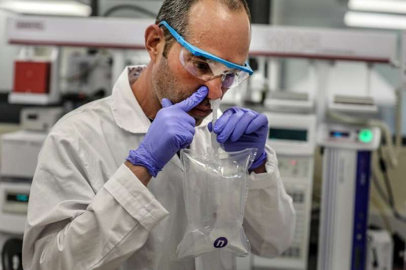 A researcher demonstrates a coronavirus breathalyser test at NanoScent's lab in Israel