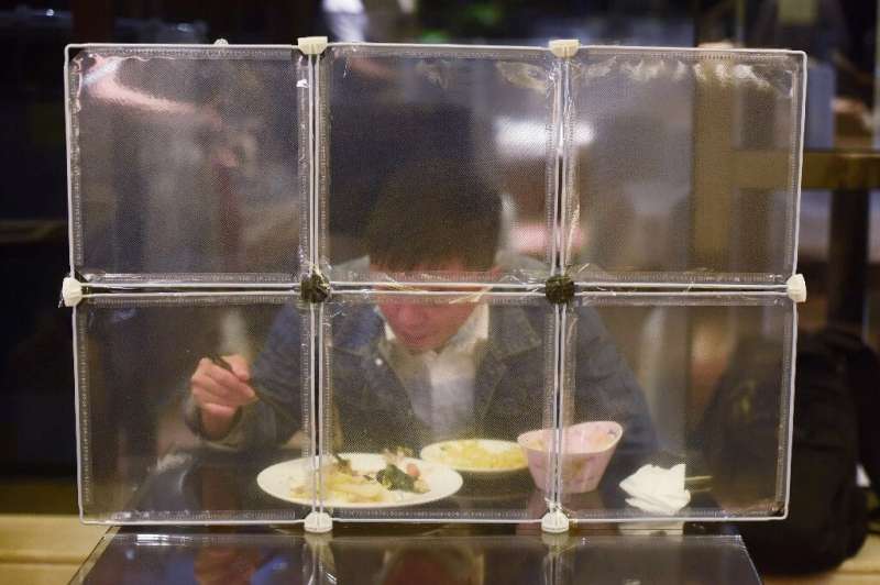 A restaurant in China's eastern Zhejiang province seperates diners with table partitions to prevent coronavirus spread