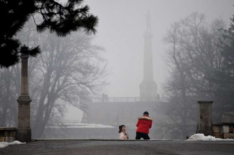 A tourist poses for a picture near &quot;The Victor&quot; (Pobednik) monument in Belgrade