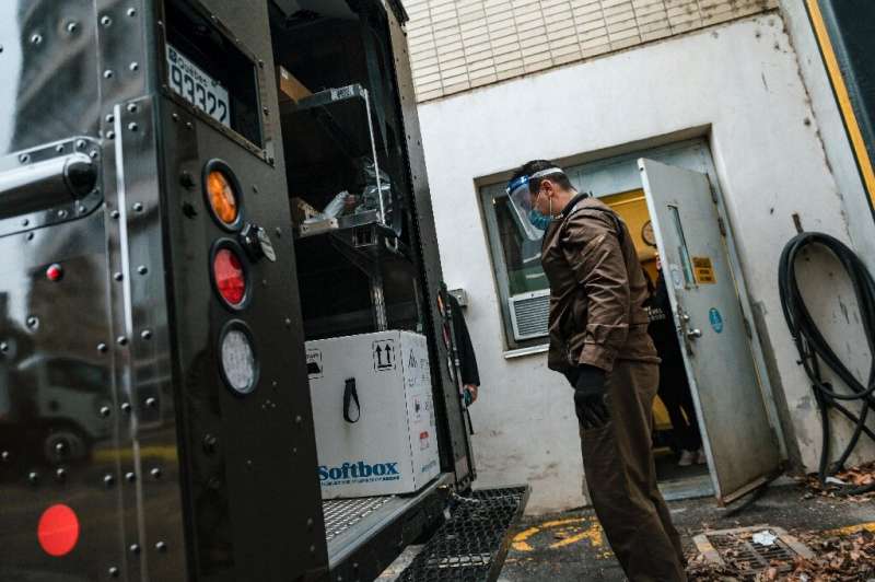A UPS employee looks at a box with some of Canada's first Covid-19 vaccines in Montreal, Quebec on December 14, 2020