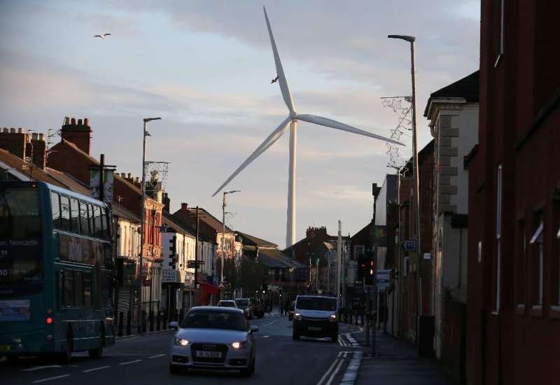 A wind turbine looms over Blyth, northeast England on December 13, 2019; Turnover in Britain's low carbon and renewable energy s