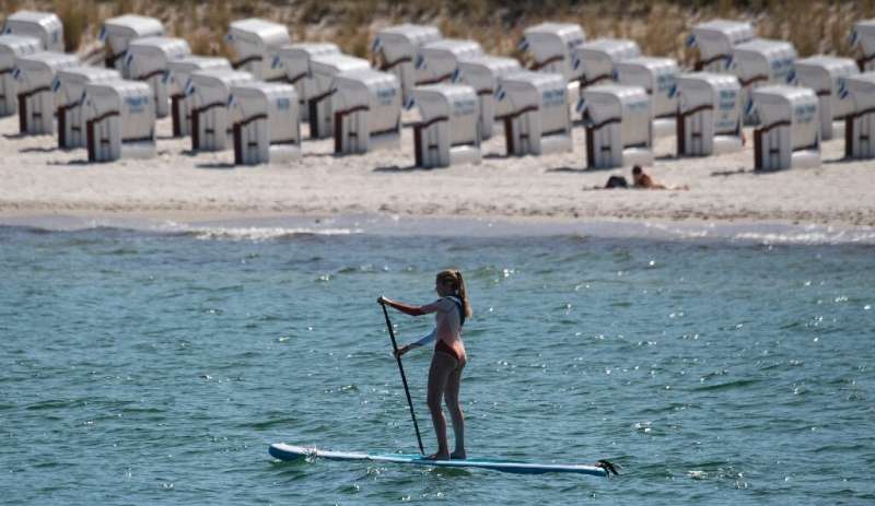 A woman on her paddle board at the seaside resort of Binz, on the island of Ruegen in northeastern Germany.