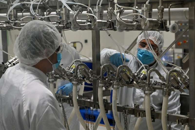 Biochemists work inside a buffer preparation room at Takeda Pharmaceuticals (Asia Pacific) in Singapore. The city-state's  coron