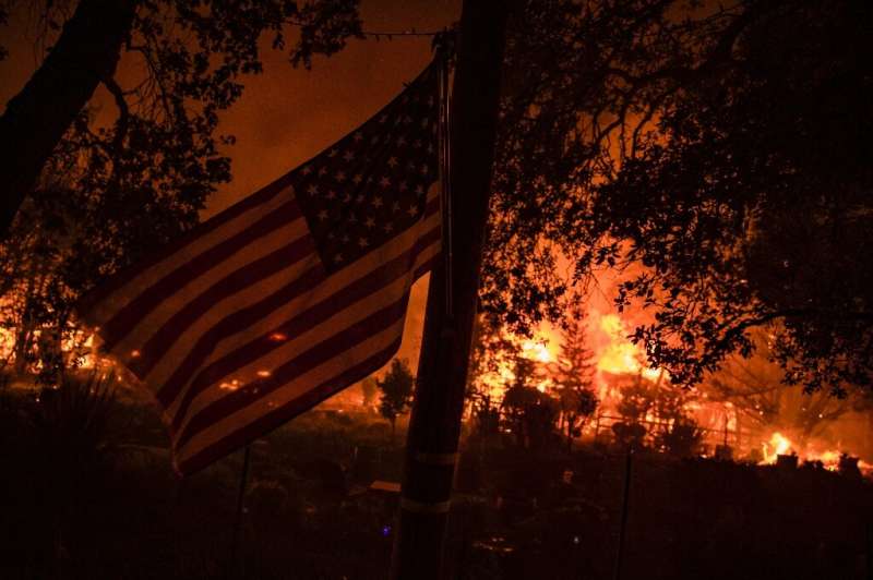 Buildings burn along Highway 12 as fire approaches Santa Rosa,  California on September 28, 2020