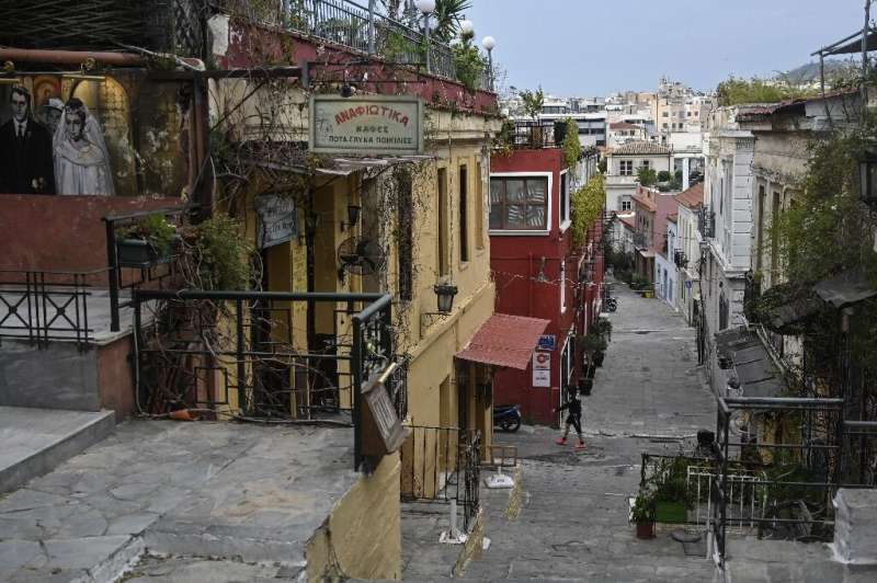 Cafes and taverns are closed in the popular Plaka tourist district of Athens during a lockdown aimed at curbing the spread of th