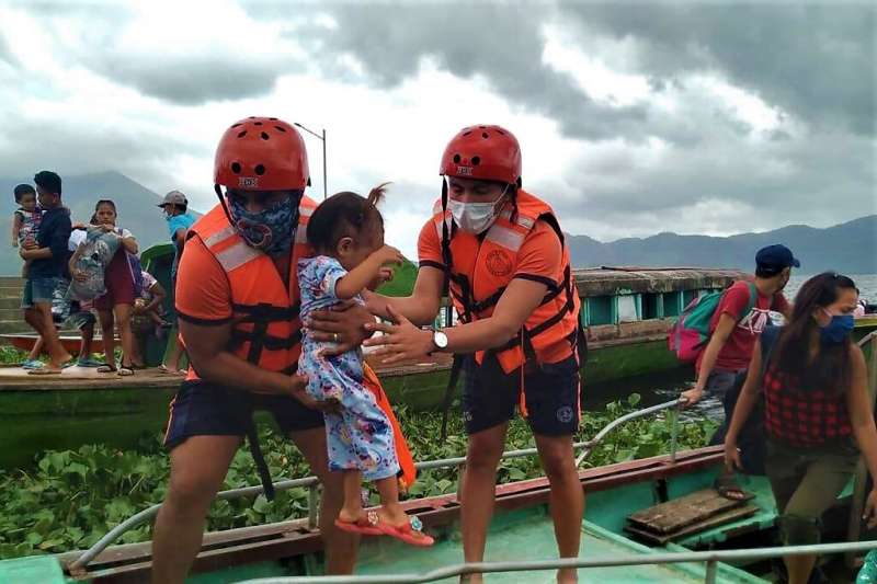 Coastguard workers evacuate residents from the coastal villages of Buhi town, Camarines Sur province, south of Manila
