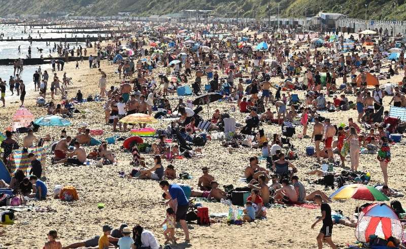 Crowds flock to a beach in Bournemouth,  England, following the easing of some lockdown restrictions