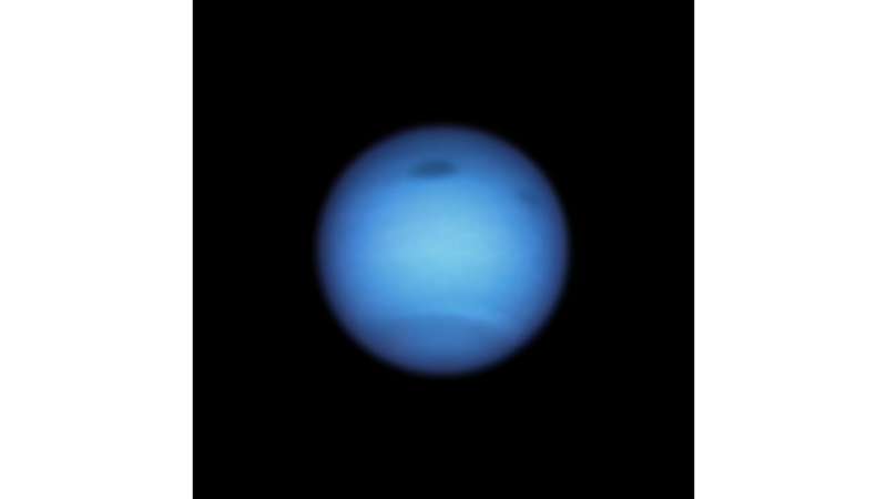 Dark storm on neptune reverses direction, possibly shedding a fragment