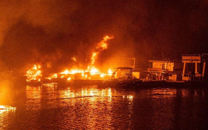 Docked boats burn on Lake Berryessa during the LNU Lightning Complex fire in Napa, California on August 19, 2020