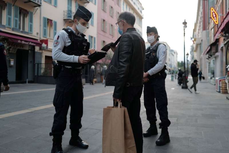 French police officers control passersby in Nice, during the country's second lockdown aimed at containing the spread of covid-1