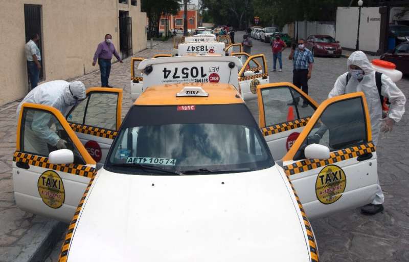 Health workers sanitize private vehicles and taxis to prevent the spread of Covid-19 in Escobedo, Mexico