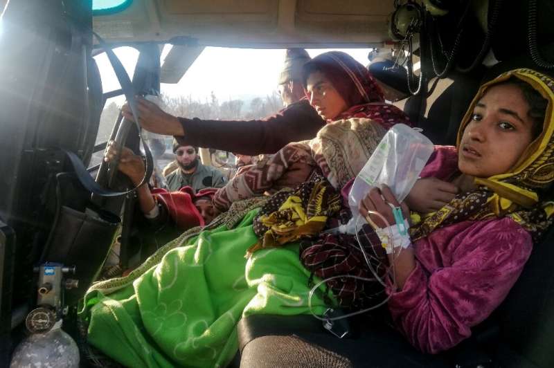 Injured avalanche victims arrive in an army helicopter in Muzaffarabad, the capital of Pakistan-administered Kashmir, following 