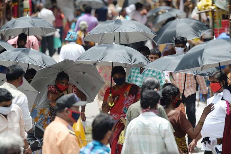 In the Indian city of Chennai, umbrellas have been distributed by volunteers to encourage social distancing