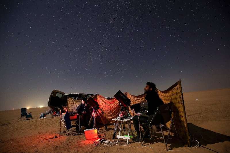 Kuwaiti astrophotographers follow the great conjunction between Jupiter and Saturn in al-Salmi district, west of Kuwait City, on