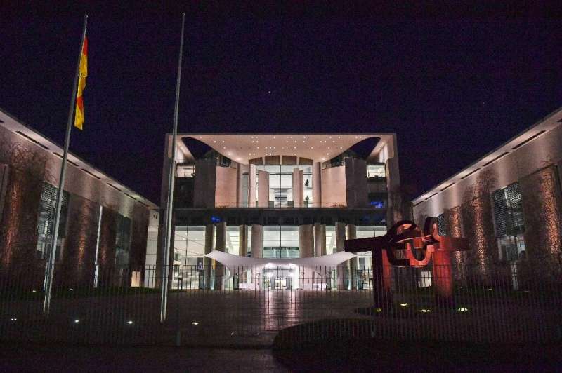 Lights are on at the Chancellery in Berlin after German Chancellor Angela Merkel made a press statement on the spread of the new