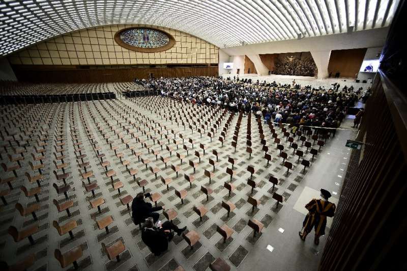 Limited worshippers attend an audience with Pope Francis at the Vatican.