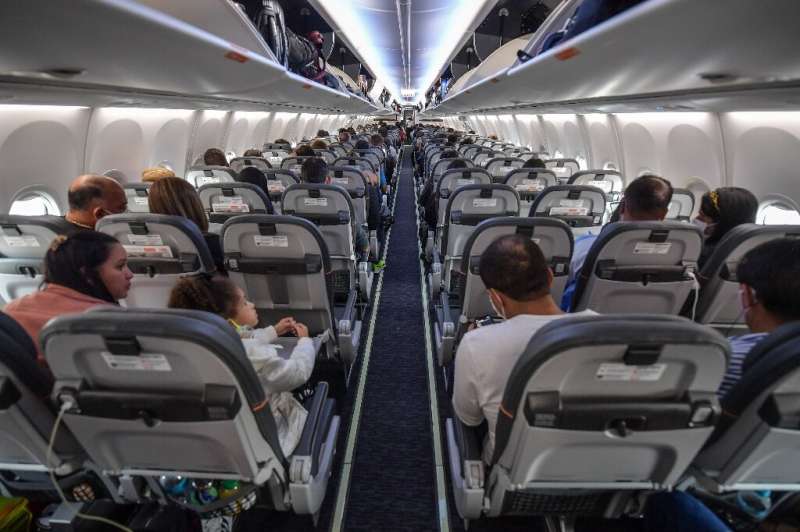 Passengers take their seats before take off in a Boeing 737 MAX aircraft operated by low-cost airline Gol at Guarulhos Internati