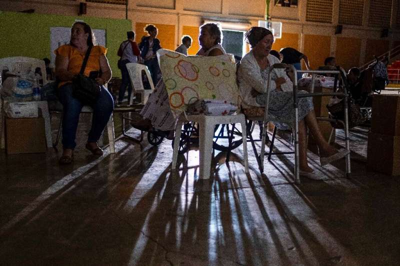 People are seen at a shelter set up after an earthquake damaged several houses in Guanica, Puerto Rico on January 6