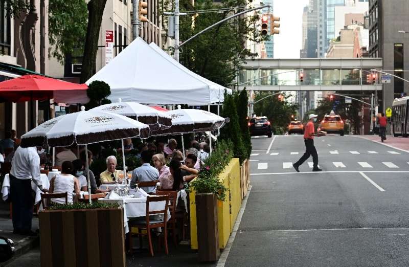 People dining outside a restaurant in Manhattan as New York tries to get back its famous energy after the COVID crisis