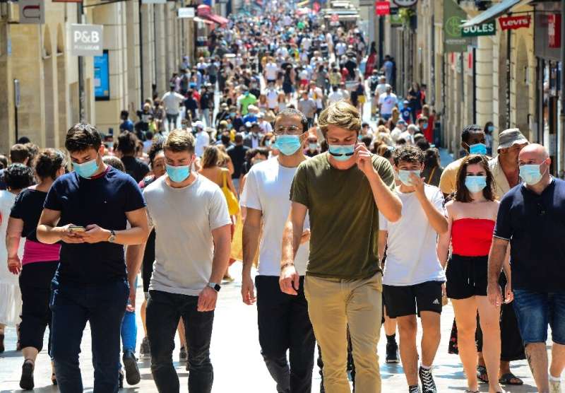 People stroll down Bordeaux's main shopping street Sainte-Catherine, where wearing a mask is compulsory as of August 15, 2020, t