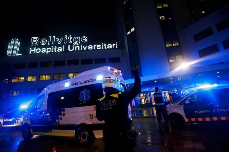 Police and other security forces gather outside the Bellvitge hospital near Barcelona to applaud and cheer healthcare workers