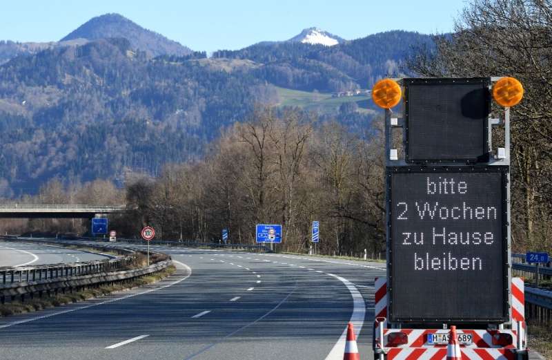 &quot;Please stay home for two weeks,&quot; reads a sign on a highway near the Austrian-German border