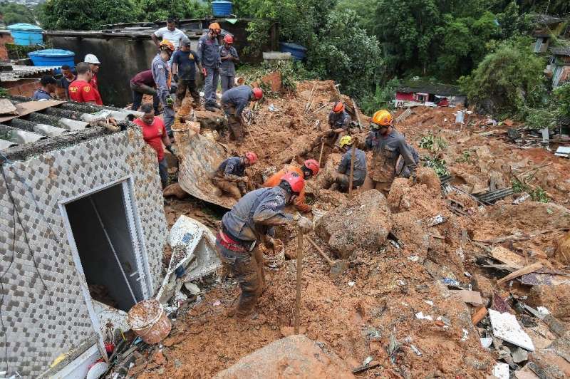 Rescuers search for victims at the Morro do Macaco Molhado favela in the coastal city of Guaruja, Sao Paulo, after it was struck