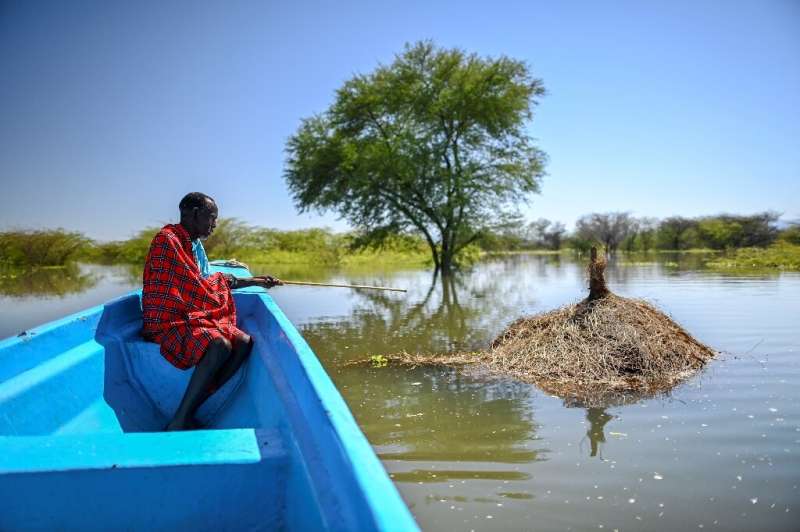 Richard Lichan Lekuterer, 60, sits in a boat as it glides above what used to be his homestead