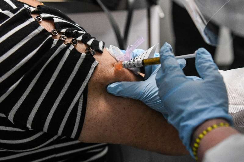 Sandra Rodriguez, 63, receives a COVID-19 vaccination at the Research Centers of America in Hollywood, Florida—volunteers in the