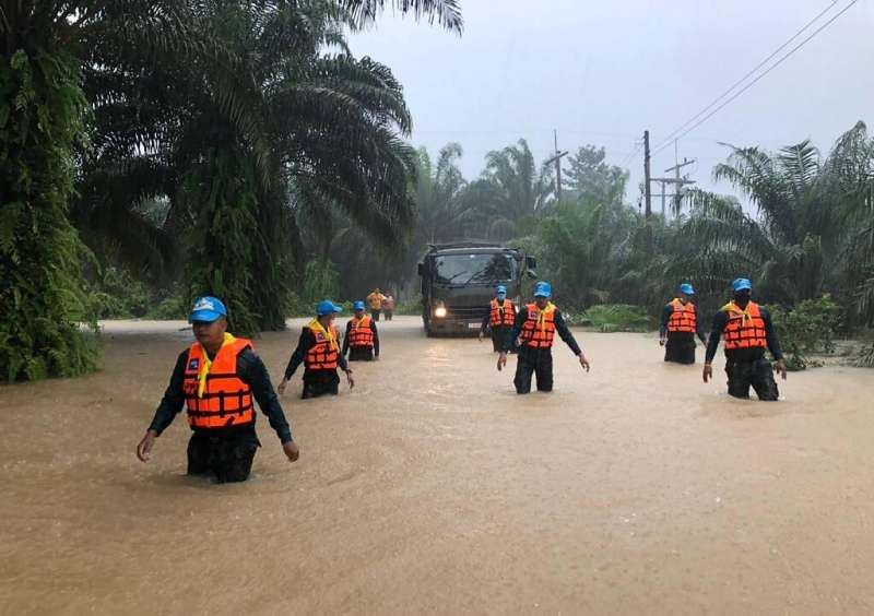 Security forces wade through flood waters in Surat Thani province in southern Thailand