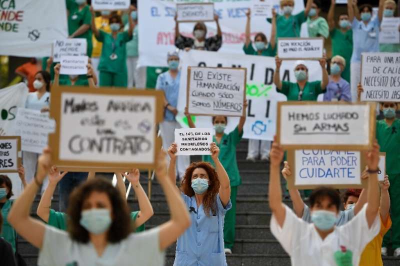 Spanish healthcare workers call for a reinforced healthcare system outside the Gregorio Maranon hospital in Madrid