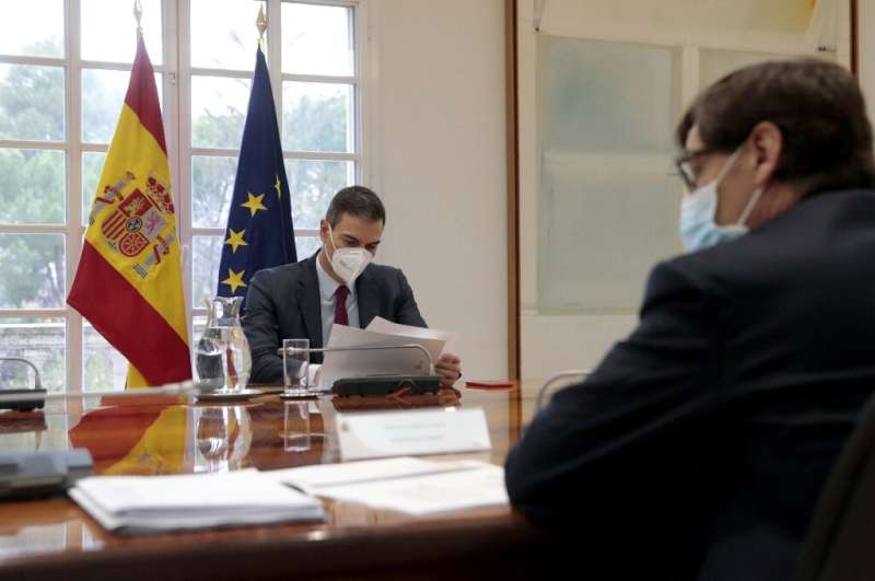 Spanish Prime Minister Pedro Sanchez (L) has gone into self isolation after contact with Macron
